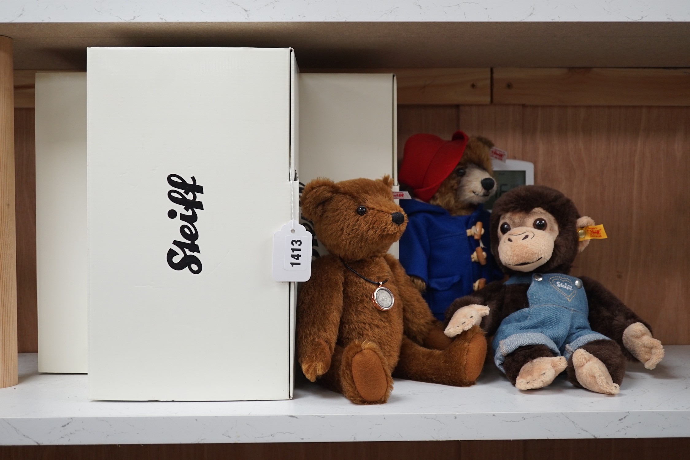 Three boxed Steiff toys: a Paddington bear, a brown bear and a monkey